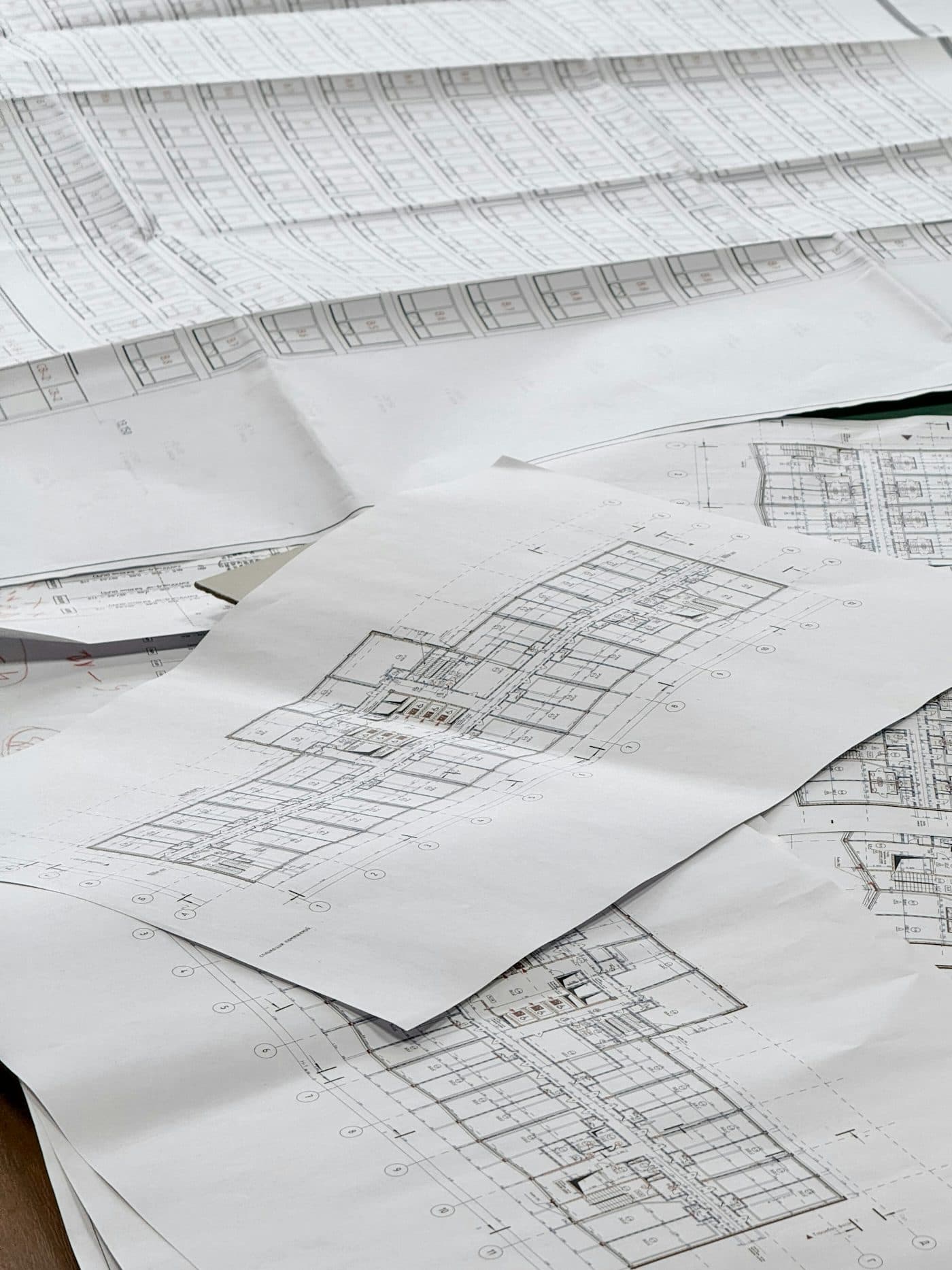 Architectural blueprints and floor plans spread across a desk — illustrative image for the demo