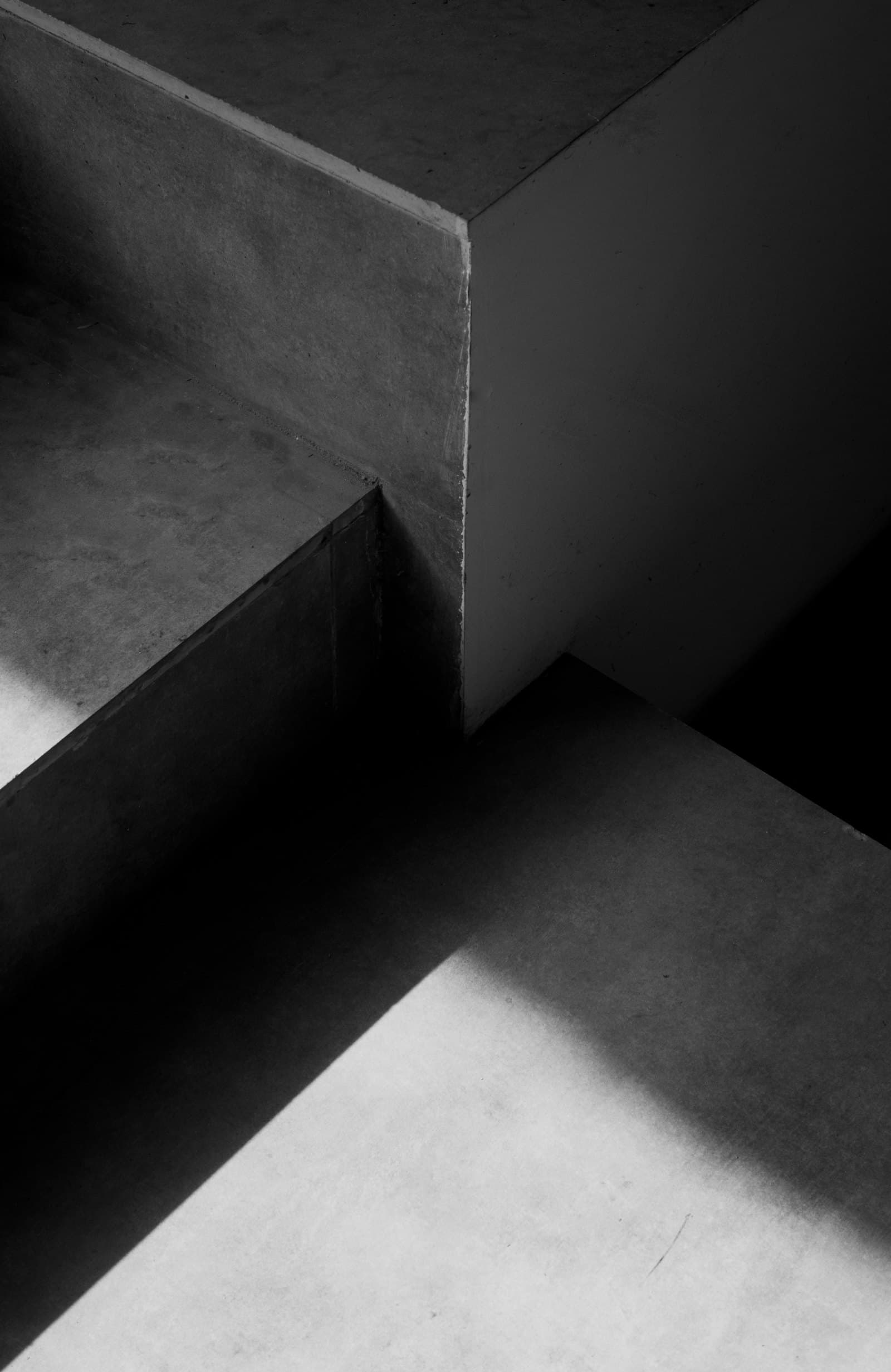 Architectural concrete detail with stairs and beams in hard shadows, black-and-white photograph — illustrative image for the demo